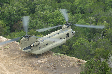 A CH-47F practicing the pinnacle maneuver whereby soldiers are deposited without the helicopter landing completely