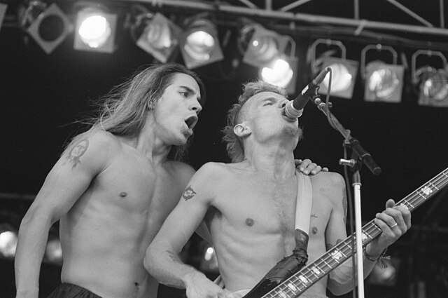 Vocalist Anthony Kiedis and bassist Flea (pictured in August 1989) have remained with the Red Hot Chili Peppers through the band's history.