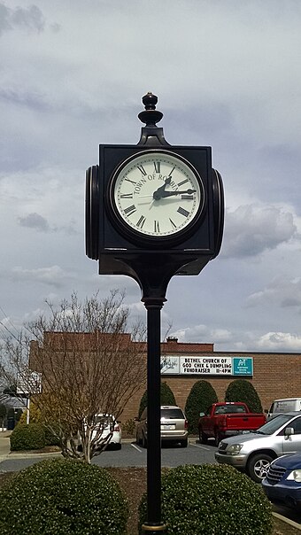 Many cities and towns traditionally have public clocks in a prominent location, such as a town square or city center. This one is on display at the center of the town of Robbins, North Carolina