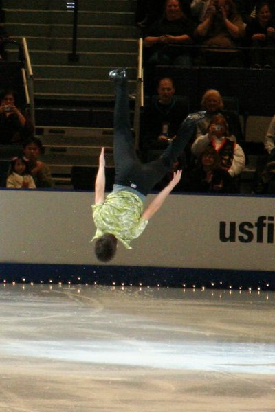 Bradley performing a back flip in exhibition at the 2006 Skate America