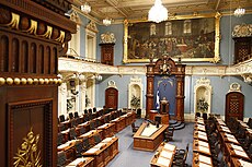The National Assembly of Quebec,formerly the Parliament of Lower Canada,first convened by Sir Alured Clarke in December 1792 (the painting in the background depicts one of the first sittings of the Parliament of Lower Canada in January 1793) Salle Assemblee nationale Quebec.jpg