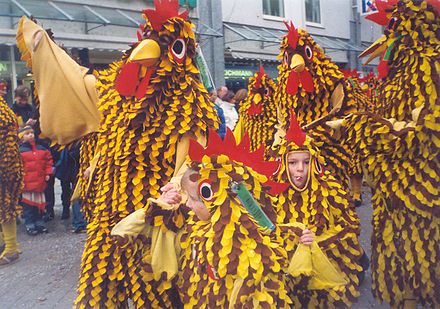 Children and adults wearing Seegockel at the carnival parade