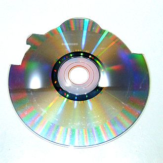 Picture of the back of a shaped CD. This CD was produced as a round disc and automatically cut to shape using a computer-aided machine with a rotary tool. It is easy to distinguish that the data track of the disc is smaller compared to a full 72-minute disc; it ends before it reaches the outside border of the disc to allow the unused media on the outside to be cut away. Shaped CD Back.jpg