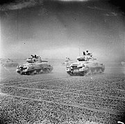Sherman tanks of the Eighth Army move across the desert