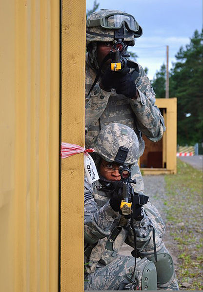 File:U.S. Army Staff Sgt. Ashley Tyler, crouching, with the 100th Security Forces Squadron, clears a building during mobile urban operations training at Sembach Air Base, Germany, July 1, 2011, before she deployed to 110701-F-EJ686-075.jpg