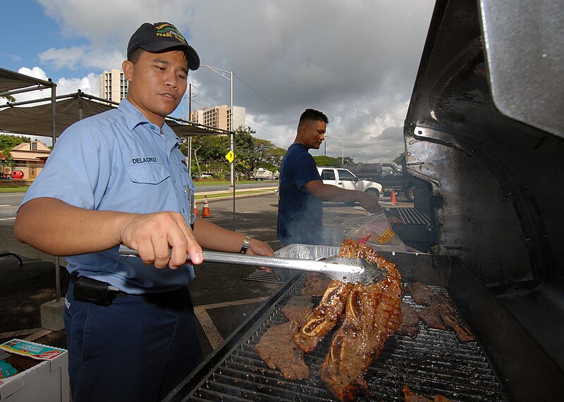 File:US Navy 070315-N-4965F-005 Culinary Specialist 1st Class Arnel Delacruz, assigned to Naval Station Pearl Harbor's Transient Personnel Unit, cooks ribs for a fund raising barbecue sponsored by the 1st Class Petty Officer^r.jpg