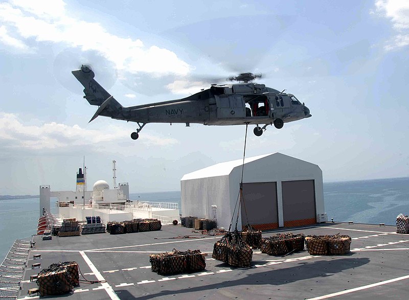 File:US Navy 090414-F-4455C-004 An MH-60S Sea Hawk helicopter carries one of the 333 loads of cargo from the Military Sealift Command hospital ship USNS Comfort (T-AH 20) as the ship is anchored offshore near Port-Au-Prince.jpg