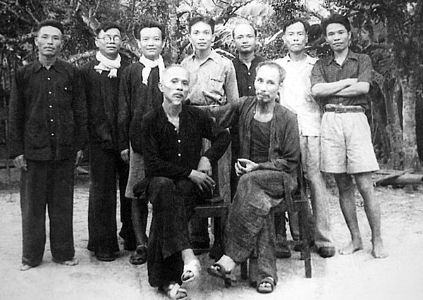 Hồ Chí Minh (seated, r) with Tôn Đức Thắng (seated, l) and other senior members of the Viet Minh, liberated zone, northern Vietnam, 1948.