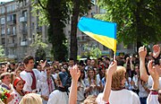A girl with the Ukrainian flag at a vyshyvanka parade