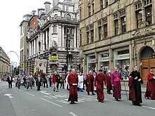 2010 Whit walks in Manchester on Cross Street showing the banner and clergy from Manchester Cathedral Whit walks Manchester.jpg