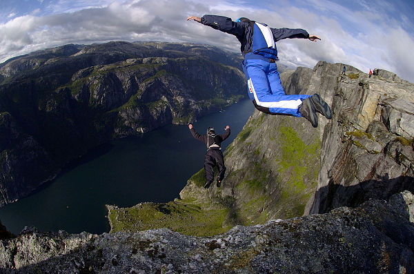 Jumpers from a cliff wearing tracking suits