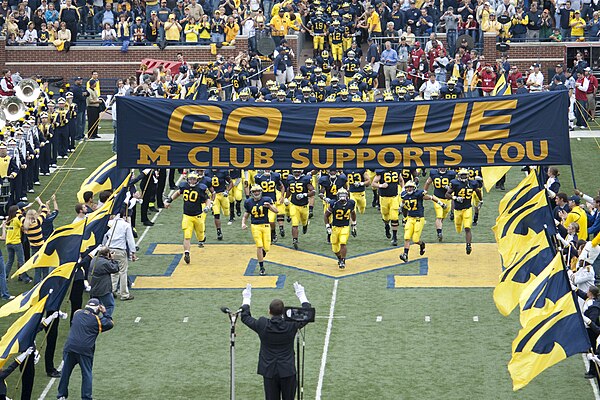 Michigan Marching Band salutes the 2009 Michigan Wolverines football team as it enters the field at Michigan Stadium.