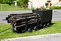 Two mine carts, at the edge of the RD 619.