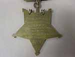 Closeup of star-shaped medal's back side