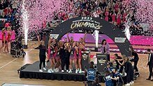 Thunderbirds players celebrating with the trophy after winning the 2023 Suncorp Super Netball Grand Final. Adelaide Thunderbirds Trophy 2023.jpg