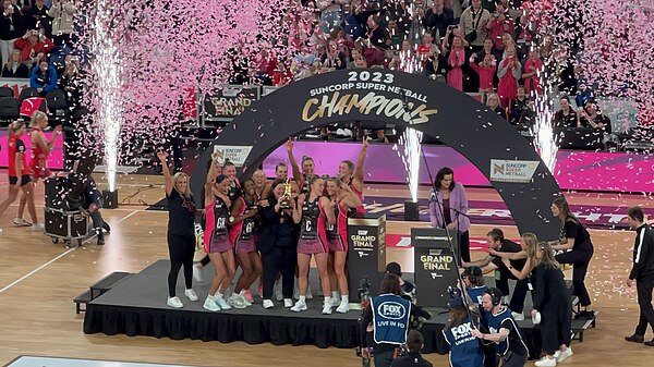 Thunderbirds players celebrating with the trophy after winning the 2023 Suncorp Super Netball Grand Final.