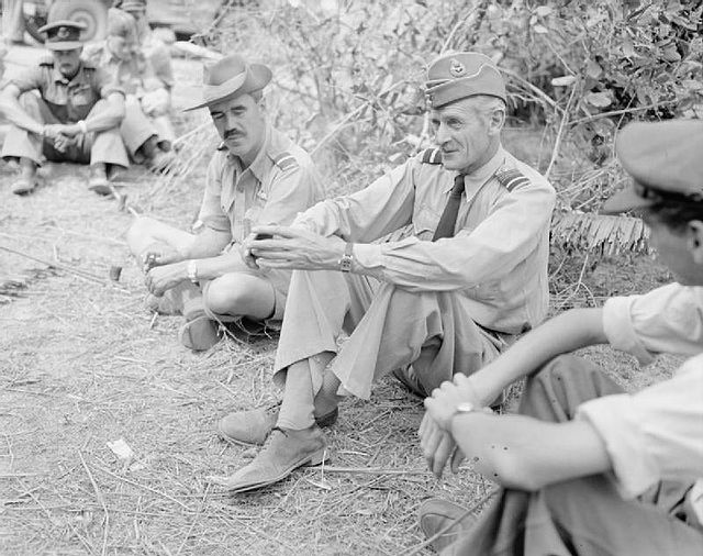 Air Commodore the Earl of Bandon, Air Officer Commanding No. 224 Group RAF, sits to the right of Keith Park at Kyaukpyu landing ground, Burma