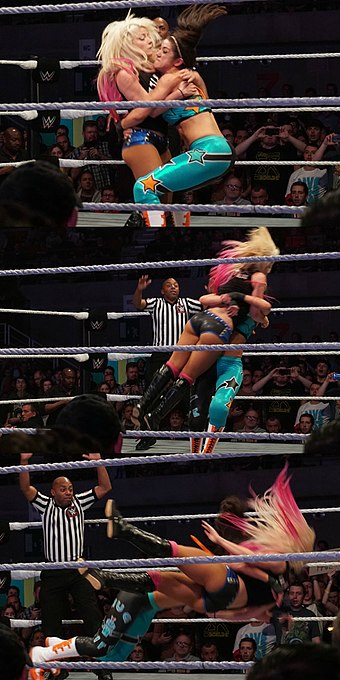 Bayley performs a Bayley-to-belly suplex (belly-to-belly suplex) on Alexa Bliss