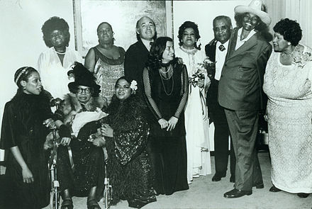 Rosetta Reitz with the Performers of the Blues is a Woman Concert at the Newport Jazz Festival; (standing, l to r): Koko Taylor, Linda Hopkins, George Wein, Rosetta Reitz, Adelaide Hall, Little Brother Montgomery, Big Mama Thornton, Beulah Bryant;  (seated, l to r): Sharon Freeman, Sippie Wallace, Nell Carter
