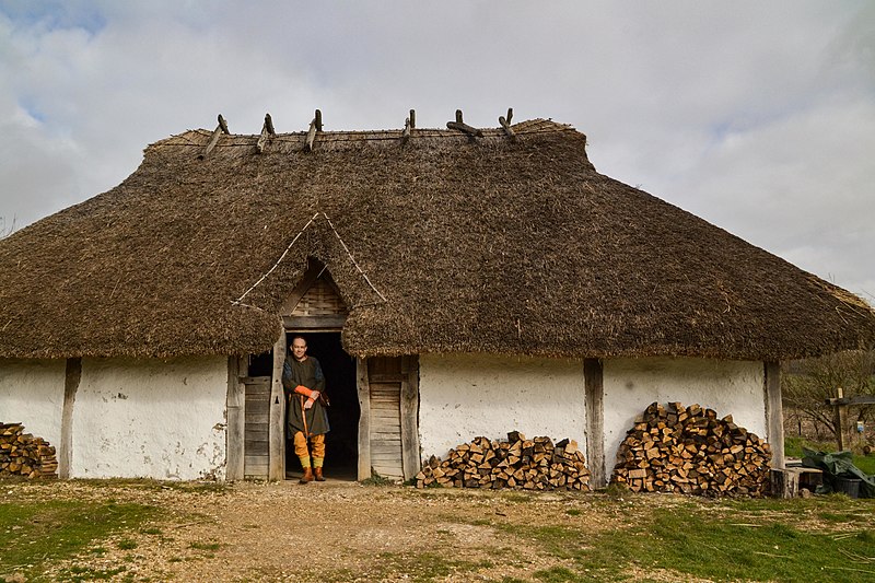 File:Butser Ancient Farm Saxon Hall with re-enactor .jpg