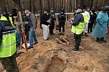 Bodies being exhumed from mass graves in Izium Cemetery in Izium made during Russian occupation (07).jpg