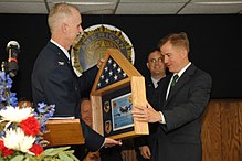 Col. Steve Arthur presents Missouri Governor Matt Blunt with an American flag flown on a combat mission over Afghanistan and certificate following a bill-signing ceremony in Warrensburg, Missouri in 2008 Commander presents flag to Missouri governor.jpg