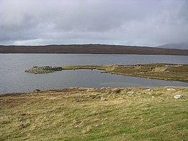 An upland lake surrounded by rough grassland