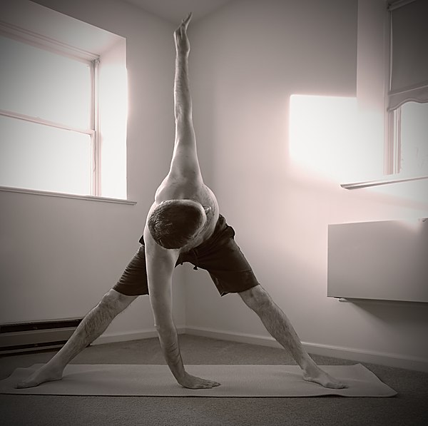 Windmill pose, close to position five of Satyananda Yoga's sequence version of Trikonasana