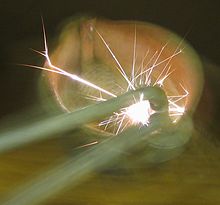 A ferrocerium "flint" spark lighter in action Flint spark lighter striking.jpg