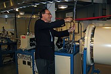 President Christopher Dahl cuts the ribbon on Geneseo's 1.7 MeV tandem Pelletron particle accelerator. Geneseo Pelletron ribbon-cutting.jpg