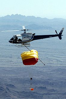 A helicopter with a long hook can catch a parachuting object in mid-air, as seen here in a practice run for the planned retrieval of Genesis. Genesis retrieval.jpg