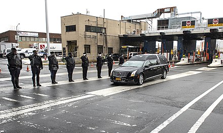 Officers of the Metropolitan Transportation Authority and a state police honor guard saluting Cuomo's hearse as it passes through the Queens Midtown Tunnel, January 6, 2015