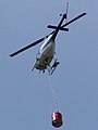 Helicopters Otago ZK-HWK Bell 206B departing the refuelling area to fight the Mt Allan forest fire near Dunedin in New Zealand