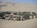 Huacachina in Peru, as seen from one of the sand mountains.jpg
