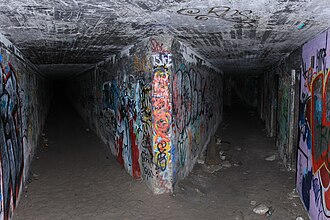 Looking in through the main tunnel entrance. There are two tunnels that lead to two different gun emplacements with tram lines running through them. Malbar battery tunnels.jpg
