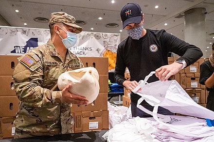 New York National Guard Assisting Volunteers packing turkeys for families facing food insecurity.