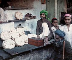 People surround one of Bombay's bread merchants by Jules Gervais-Courtellemont.jpg