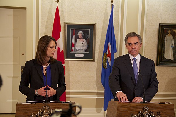 Smith and Jim Prentice announcing that she and eight other Wildrose MLAs would be crossing the floor to join the Progressive Conservatives.