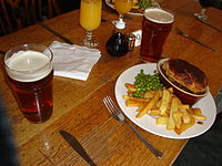 Pub grub - sebuah pai, bersama-sama dengan pint. Rumah awam awam adalah sebahagian daripada budaya budaya British,[4] Ireland,[5] Scotland,[6] dan budaya Australia.[7]