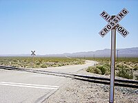 American crossbucks at the intersection of Redrock Randsburg Road and the Southern Pacific (now Union Pacific) Railroad, in the Mojave Desert near Garlock, California, May 2004 Railroad Junction2004 x.JPG