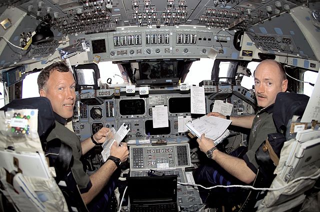 Dominic Pudwill Gorie, STS-108 commander, and pilot Mark Kelly are in their respective stations during rendezvous operations with the ISS. Pudwill Gor