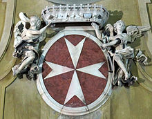 Coat of arms of the Knights of Malta from the facade of the church of San Giovannino dei Cavalieri, Florence, Italy San Giovannino dei Cavalieri stemma Cavalieri di Malta.JPG