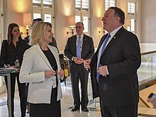 Nauert speaking with Mike Pompeo at the Singapore Summit on June 12, 2018. Secretary Pompeo Chats With Acting Under Secretary Nauert (42038494634).jpg