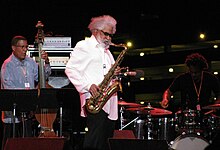 Jazz legend Sonny Rollins (pictured here shortly before his retirement from performing in 2012) voiced himself in this episode Sonny Rollins at Detroit Jazz Festival (August 31, 2012).jpg