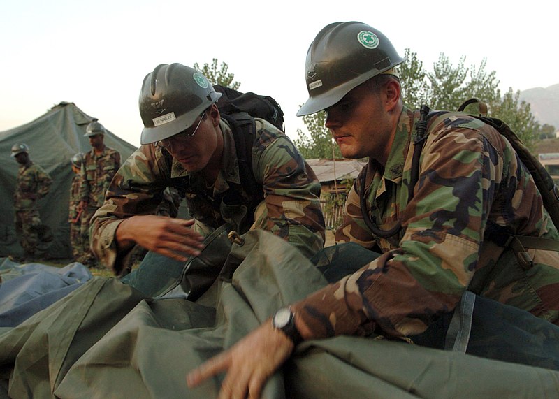 File:US Navy 051026-N-1261P-149 U.S. Navy Electronics Technician 3rd Class Erik Lazaroff, right, and Construction Electrician Jean Bennett set up berthing tents for air detachment personnel assigned to Naval Mobile Construction Batt.jpg