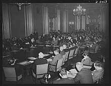 War Labor Board anthracite hearing in Washington, D.C., in January 1943: labor members, seated at the left of conference table, and employer members, seated at the right, hear testimony of striking coal miners War Labor Board anthracite hearing broad view January 1943.jpg