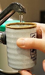 Pouring just-boiled water into a ceramic mug. Steeping is very effective