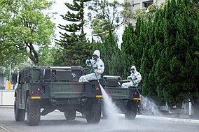 Taiwanese 33rd Chemical Corps spraying disinfectant on a street in Taipei