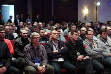 More than 700 attendees listening to keynotes on the opening session of the Open Source 2014 Day in Warsaw 700 attendees in the Main Hall listen to a keynote OSD 2014.jpg