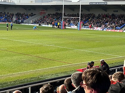 Adam Keighran preparing to kick at goal in front of the Wigan fans at Plough Lane in March 2024 Adam Keighran kicking at goal in front of the Wigan fans.jpg